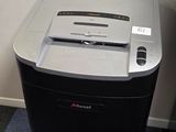 a black and white paper shredder sitting on the floor