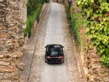 a car that is driving down the road through a tunnel
