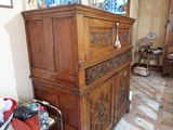 a wooden dresser with a mirror on top of it