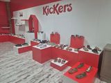 many different types of shoes on display in a store