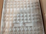 a cardboard box that has a bunch of cups inside of it