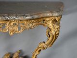 a table with a marble top and gold decoration