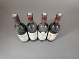 several bottles of wine are lined up on a table