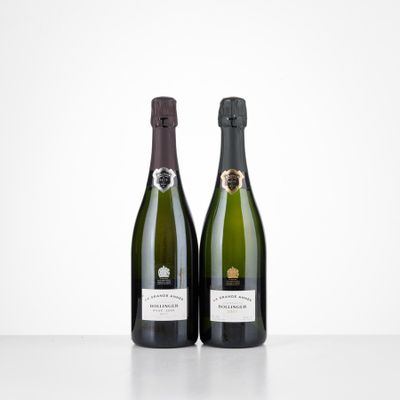 two bottles of champagne sitting on top of a table