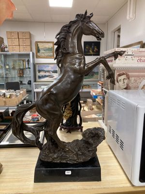 a statue of a horse that is standing on its hind legs