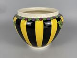 black and yellow striped bowl with flowers on the rim