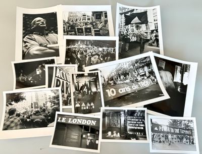 several black and white photographs of people in london on a table