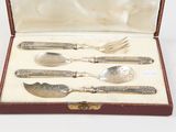 a box with silverware in it on a white surface