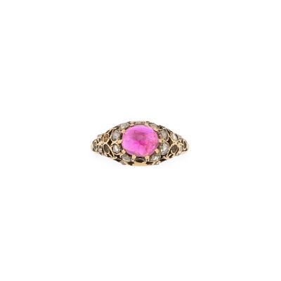 a gold ring with a pink stone surrounded by diamonds