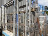 several pallets of pallets are stacked on top of each other in front of a building