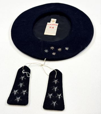 un chapeau noir orné d'étoiles argentées, à côté d'une paire d'étiquettes