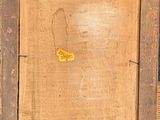 an old picture of a piece of wood with a yellow tag on it
