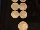 a lot of coins sitting on a table next to a pair of scissors