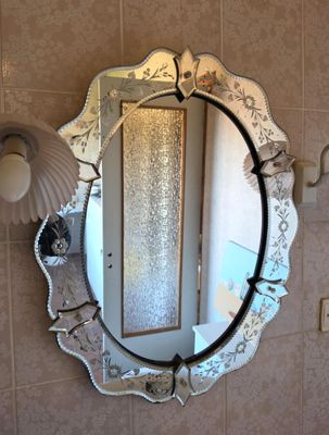 a mirror that is hanging on the wall in the bathroom