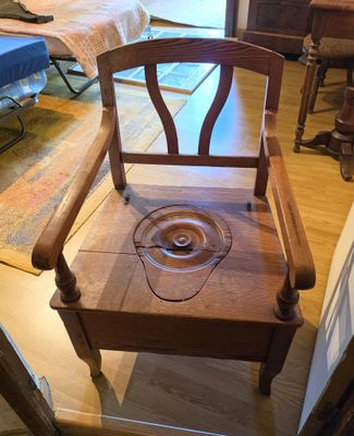 a wooden chair with a wooden seat in a room
