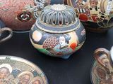 many different types of vases and plates on the table
