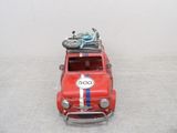 a red toy car with a bike on top of it