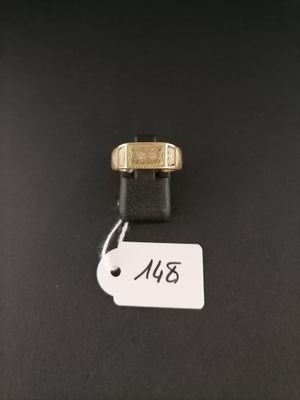 a close up of a gold ring with a tag on it