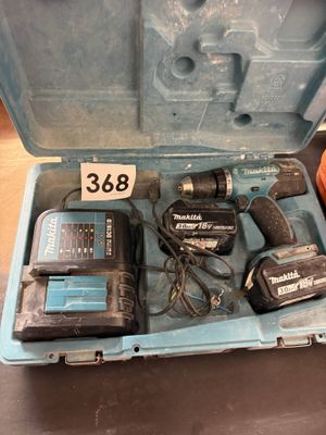 a blue tool box with tools in it on a table