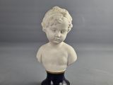 a small bust of a boy on a black base