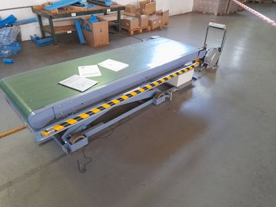 a table with a sheet of paper on it in a warehouse