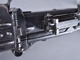a close up of a gun on a white surface