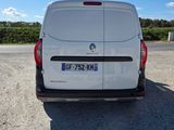 the back of a white van parked in a parking lot