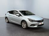the silver opel is parked in a white room
