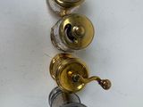 three different types of brass and silver items on a white surface