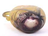 a glass vase that has a purple and white design on it