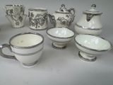 many different types of coffee cups and saucers on the table