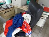a chair with a pile of clothes on top of it