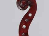 a close up of the back of a violin with a fiddle in the foreground