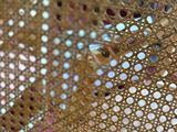 a close up picture of a chair with a basket on the back of it