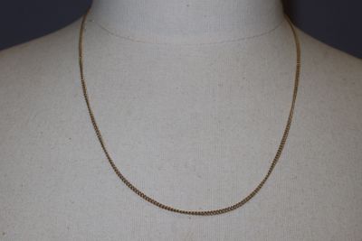 a close up of a mannequin torso with a chain on it