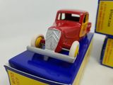 a red toy car on top of a blue and yellow box