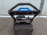 a close up of a lawn mower sitting on top of a cement block