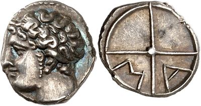 a close up of a coin with a face on it