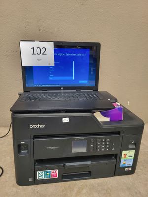 a laptop computer sitting on top of a printer