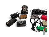 a lot of different types of cameras on the table
