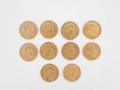 a close up of a bunch of gold coins on a white surface