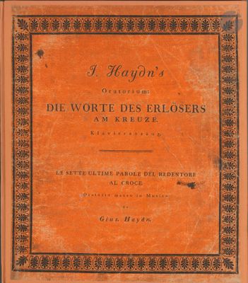 un livre avec une couverture orange bordée de noir