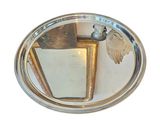 a silver plate with a bird on top of it
