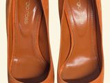 an image of a pair of orange shoes on a white background