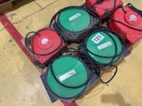 several green and red gas pumps sitting on top of a yellow floor