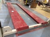 a picture of a red and white bench in a warehouse