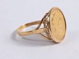 an image of a gold ring with a coin in the middle
