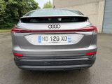 the rear end of a silver audi suv parked in a parking lot