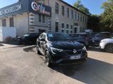a car parked in front of a building with cars parked in front of it