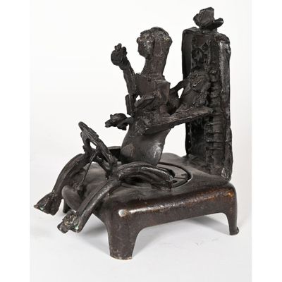 an image of a bronze statue of a woman sitting on a chair